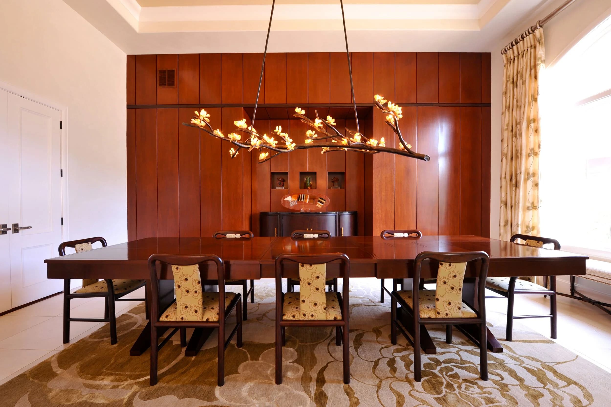 Lake Austin dining room with sculptural branch chandelier and walnut millwork